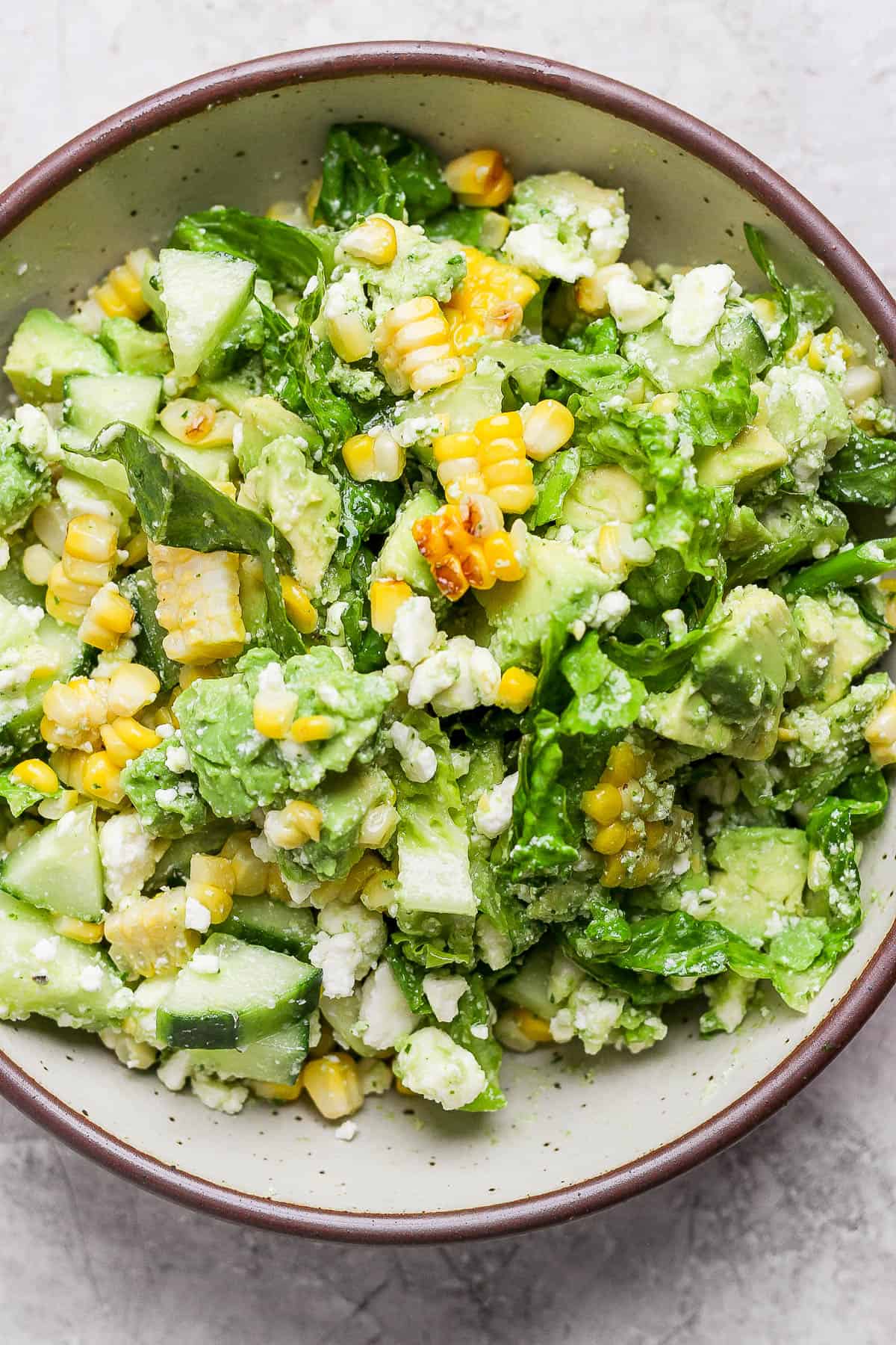 Avocado salad ingredients in a large bowl.