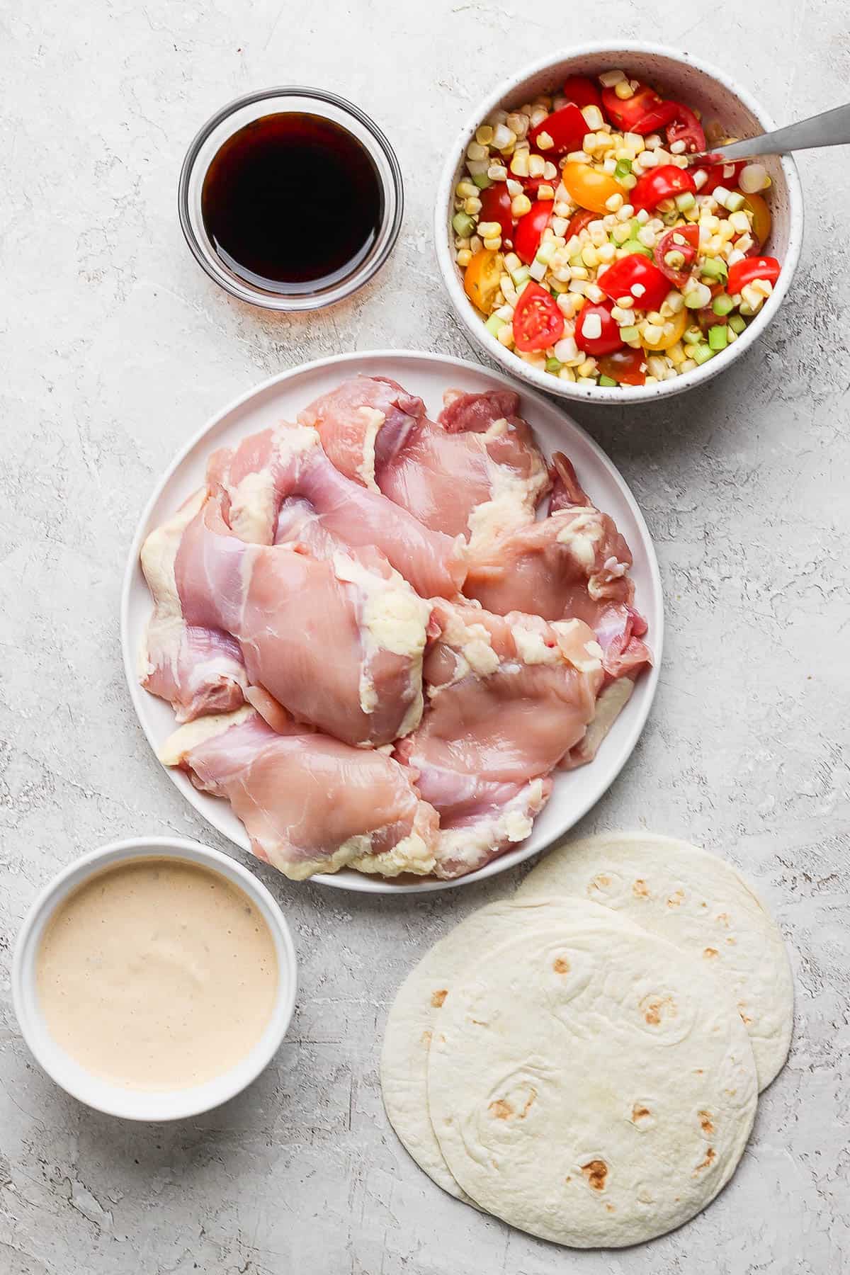 Ingredients for Blackstone chicken tacos in separate bowls.