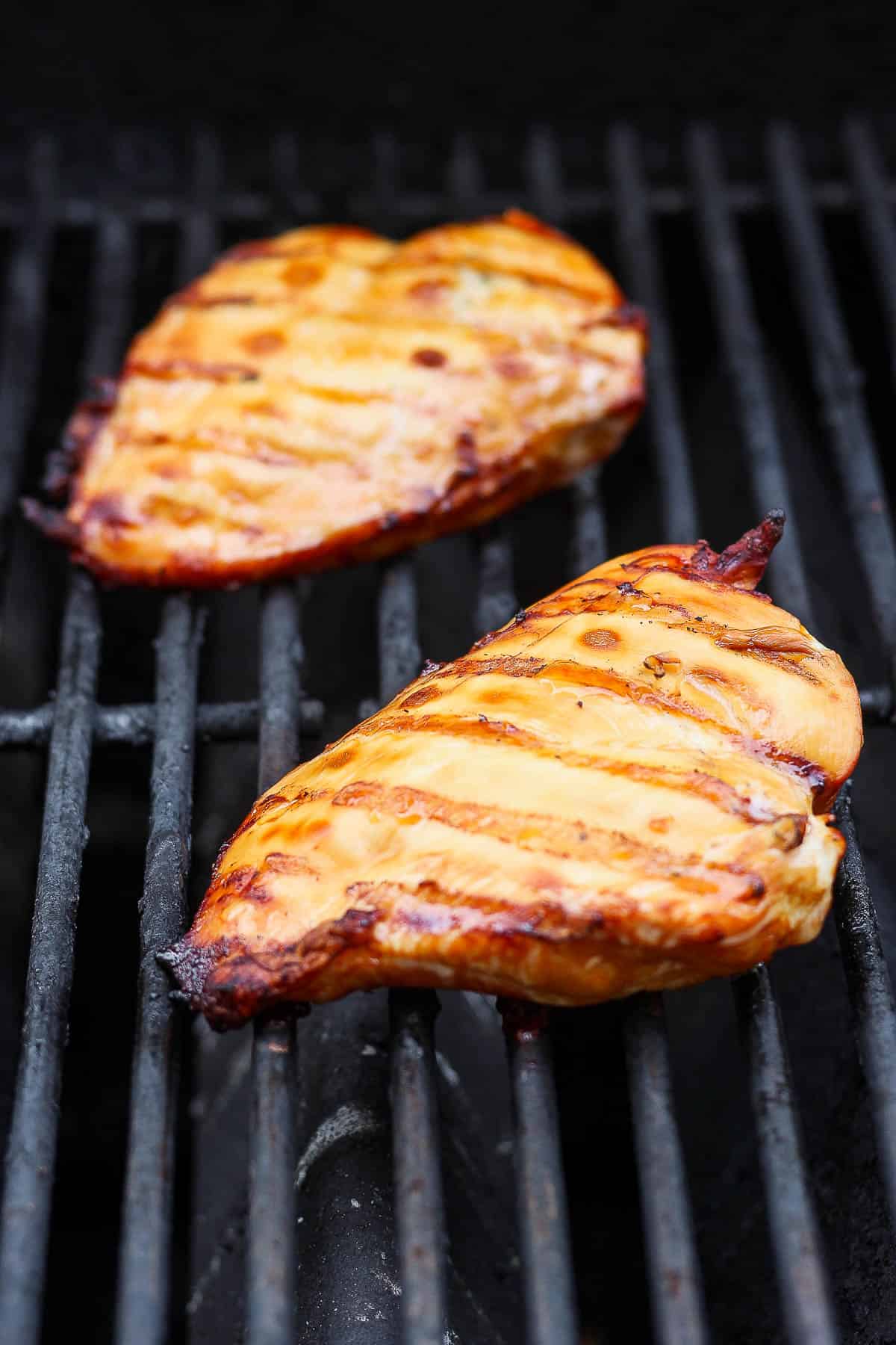 Chicken breasts cooking on the grill.