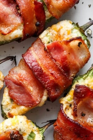 Top down shot and a close up of a bacon-wrapped grilled jalapeno popper on a plate.