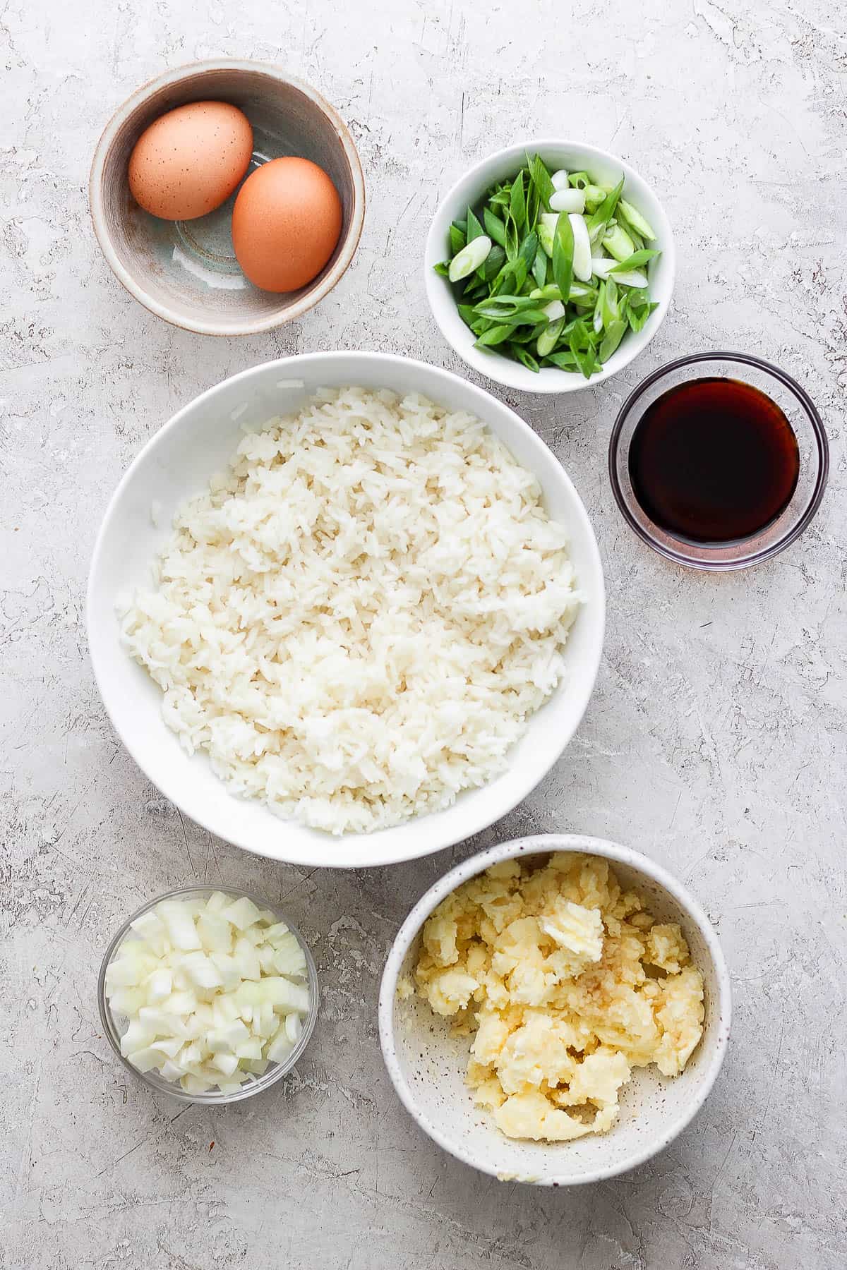 Ingredients for hibachi fried rice in separate bowls.