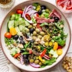 Top down shot of a big bowl of a Italian Chopped Salad with cucumbers, olives, onion, olives and cucumber.