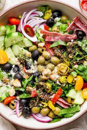 Top down shot of a big bowl of a Italian Chopped Salad with cucumbers, olives, onion, olives and cucumber.