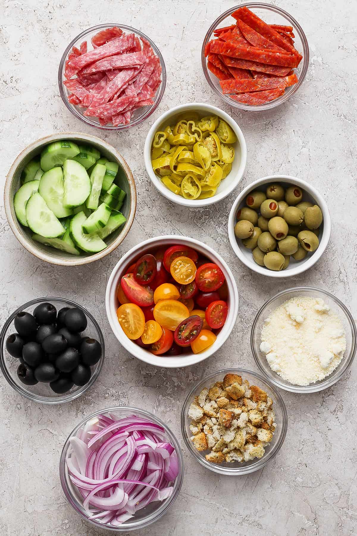 Salad ingredients in separate bowls.