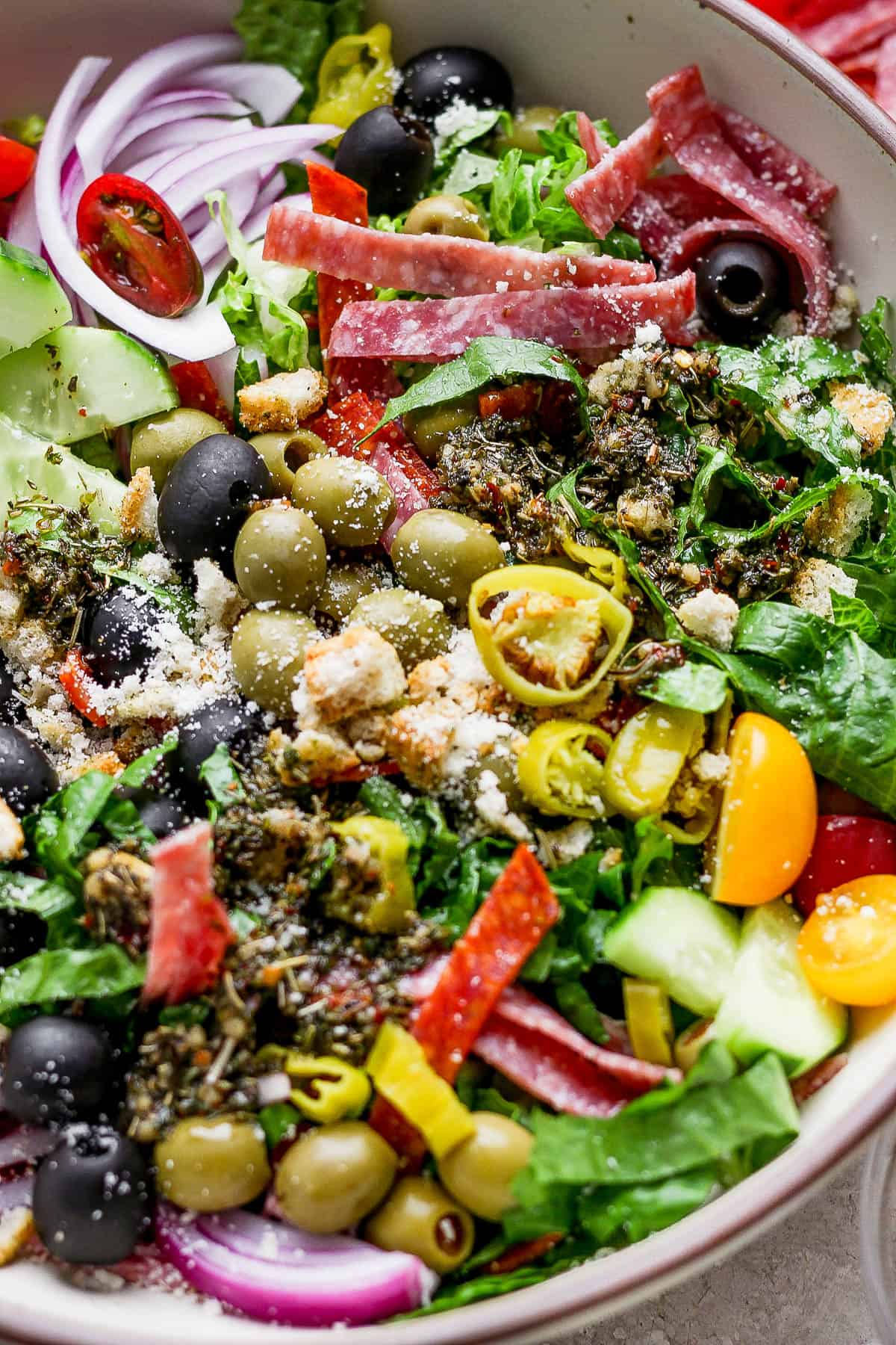 Salad ingredients in a large bowl with dressing.