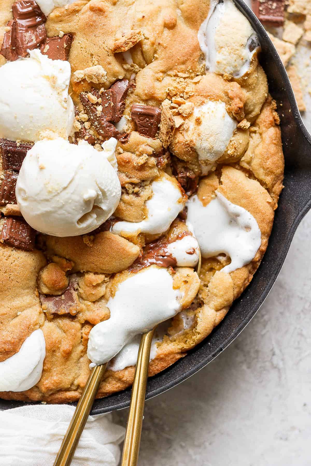 Ice cream and spoons in the cookie skillet.