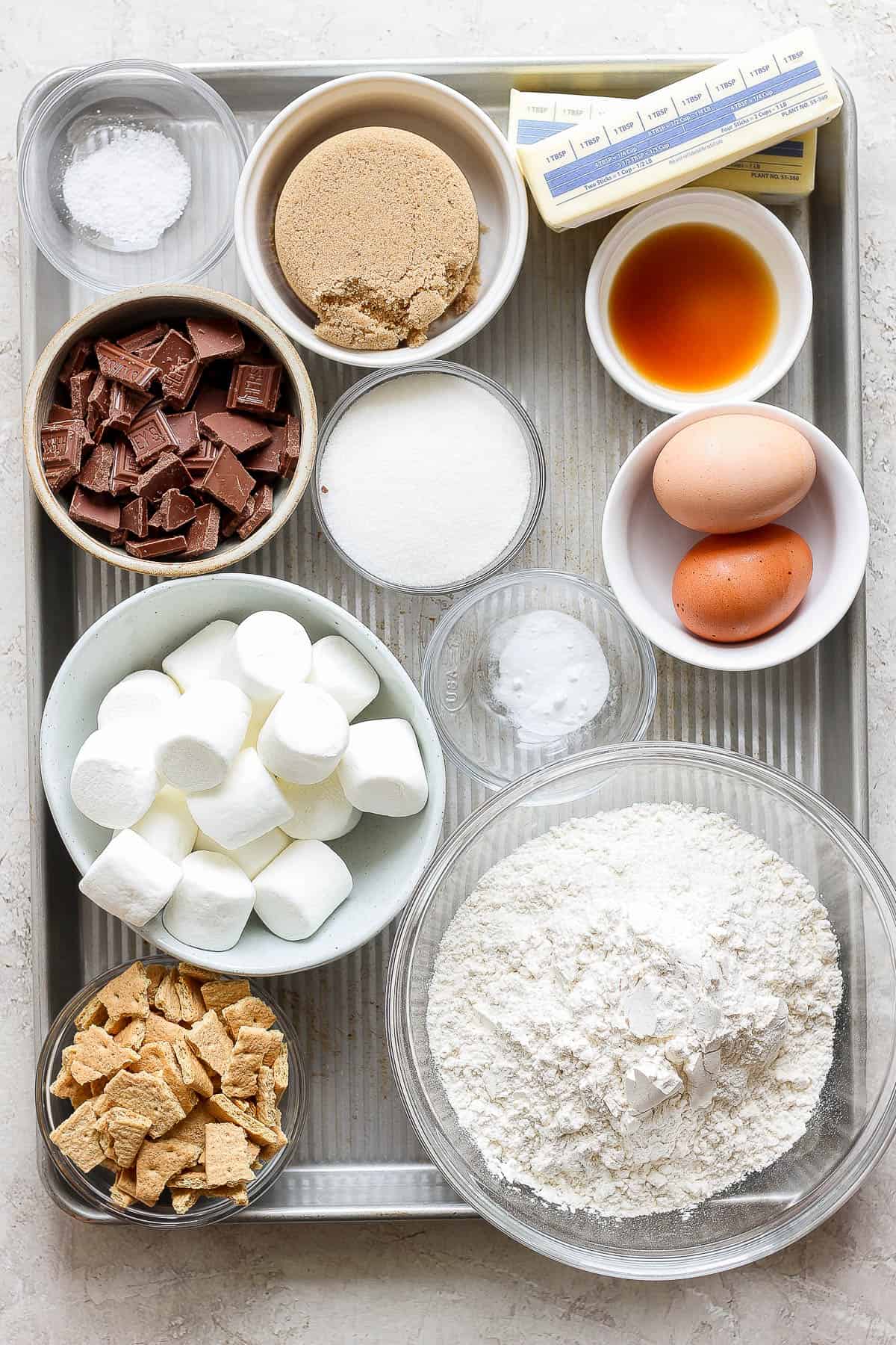 Ingredients for a s'mores cookie skillet in separate bowls.