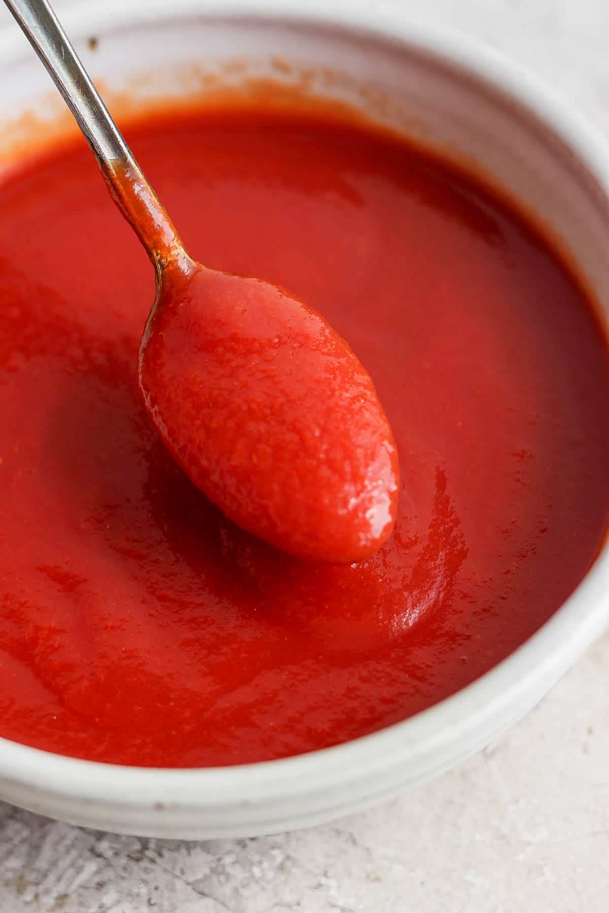 Taco dressing in a bowl with a spoon.