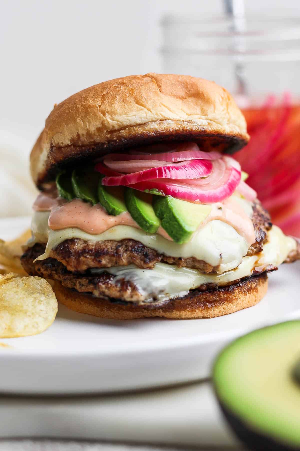 A fully assembled turkey smash burger on a plate.