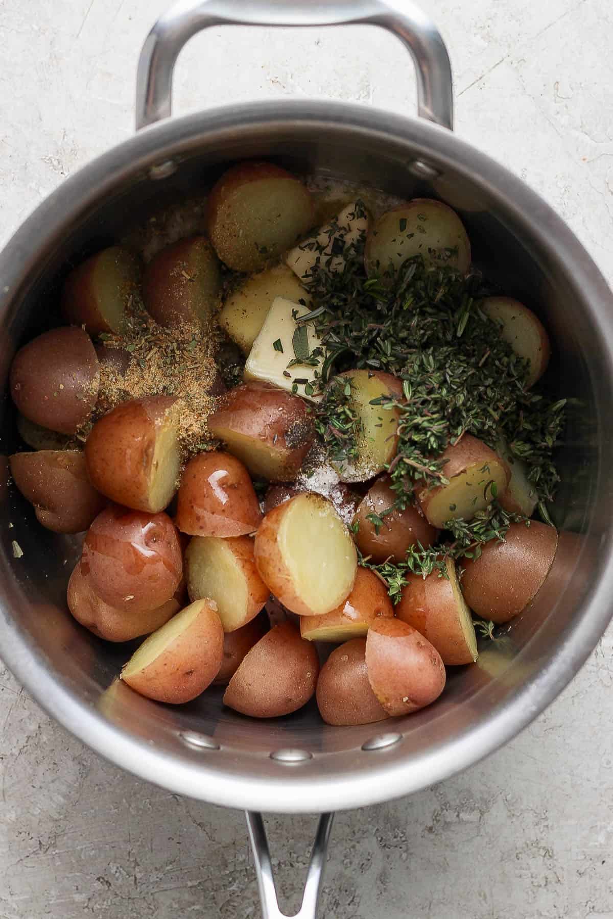 Boiled potatoes in a large pot with all the other ingredients added.