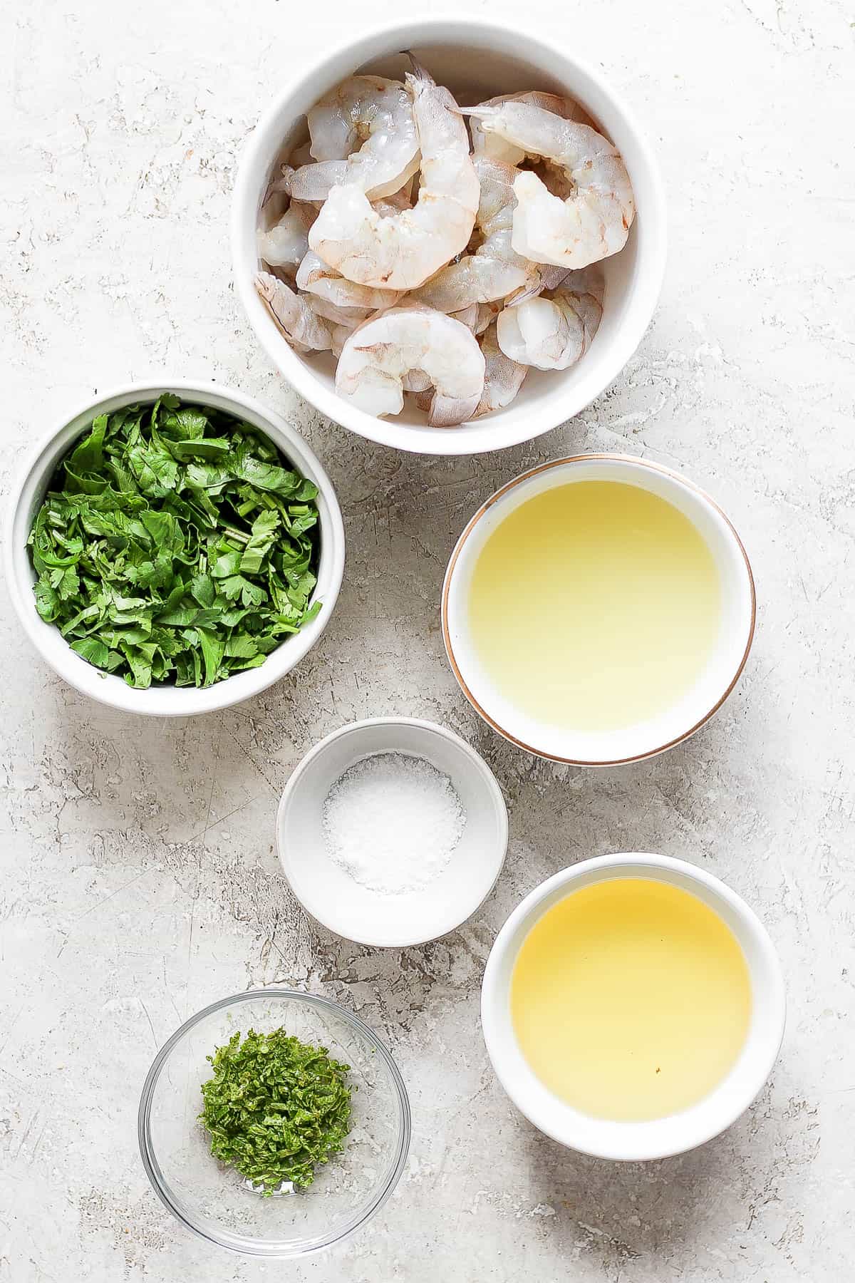 Ingredients for cilantro lime shrimp in separate bowls.