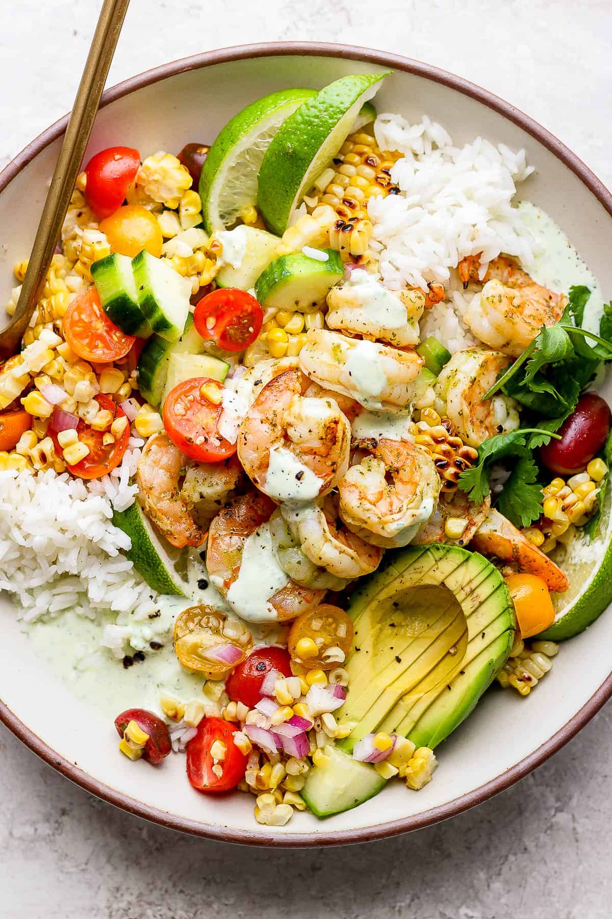 Some cilantro yogurt sauce on a shrimp rice bowl.