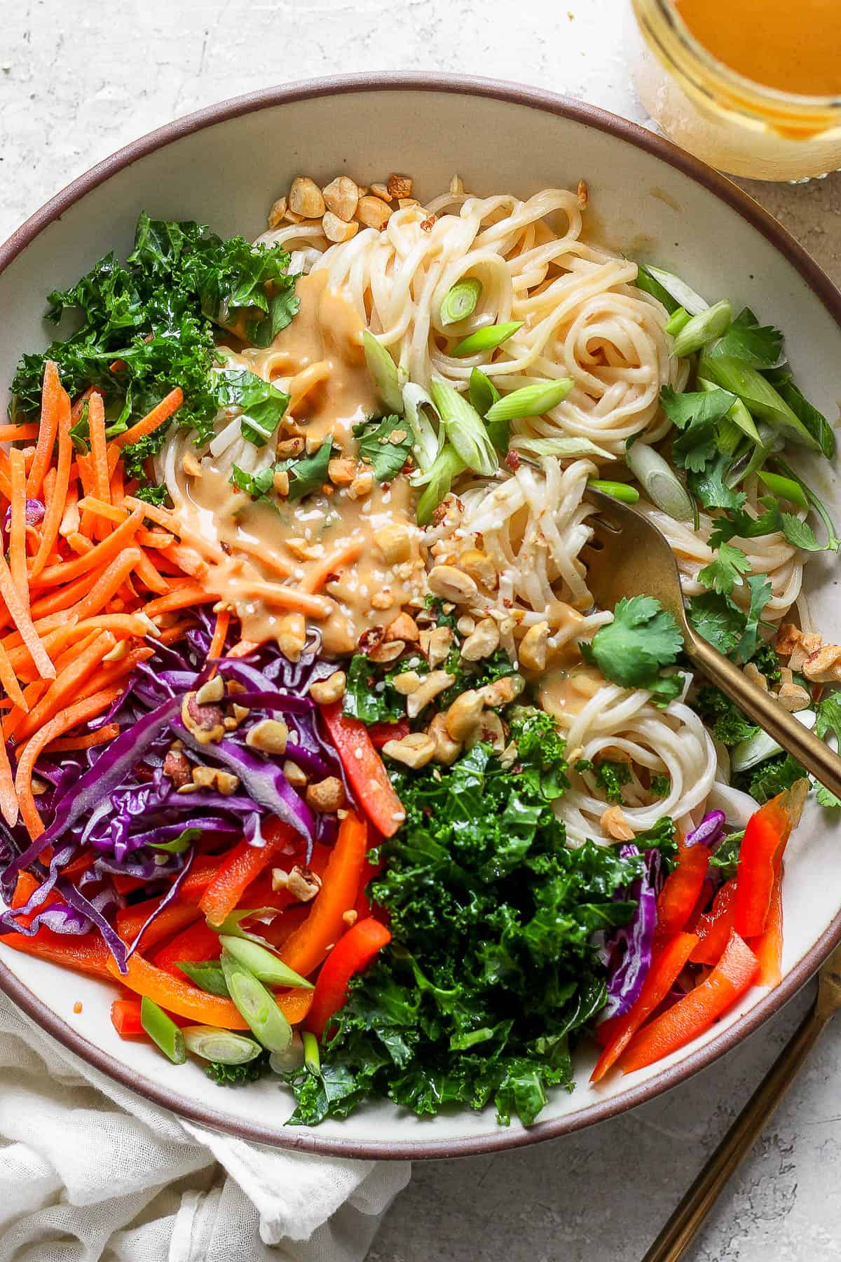 All the pieces of Thai peanut noodles in a large bowl before mixing.