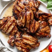 Top down shot of a plate of balsamic grilled chicken thighs.