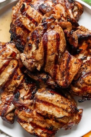 Top down shot of a plate of balsamic grilled chicken thighs.