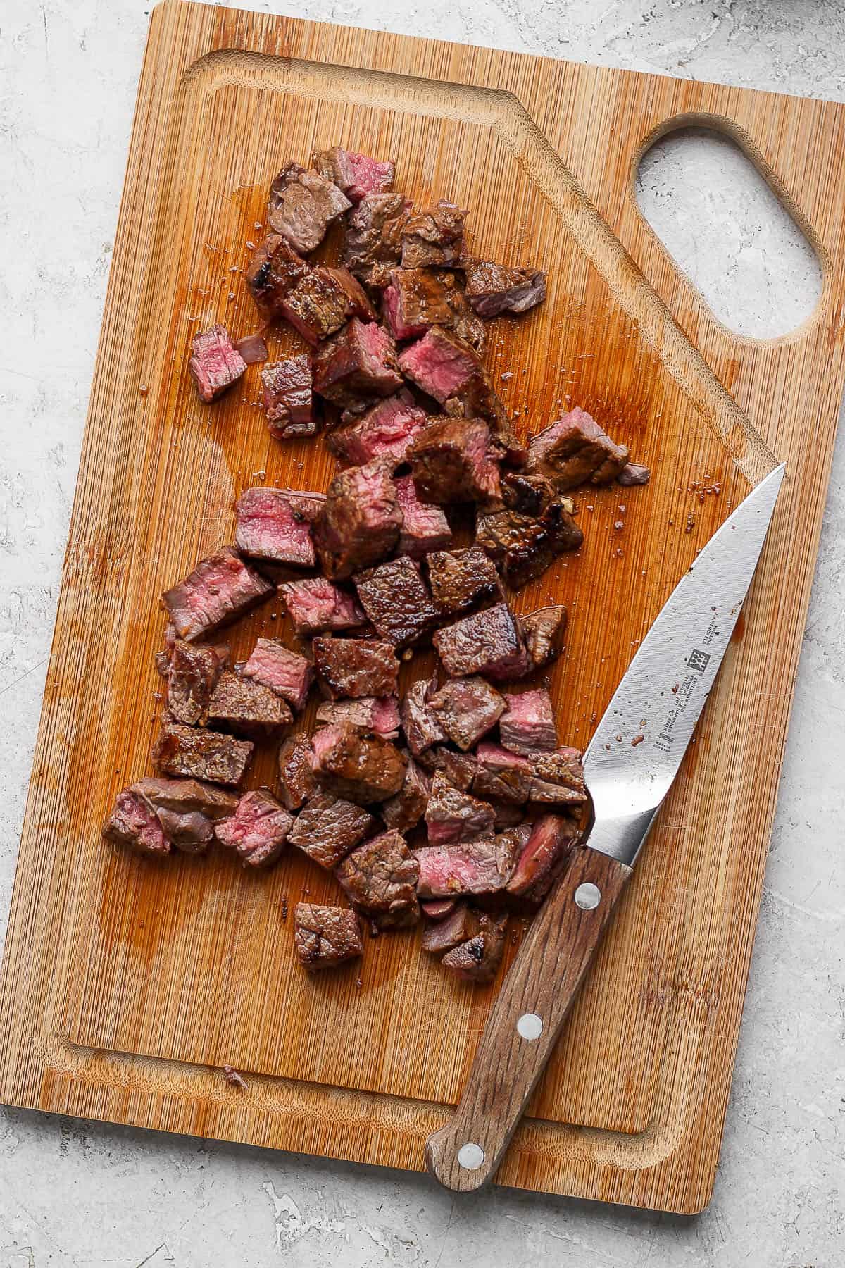 The hibachi steak cut up on a cutting board.