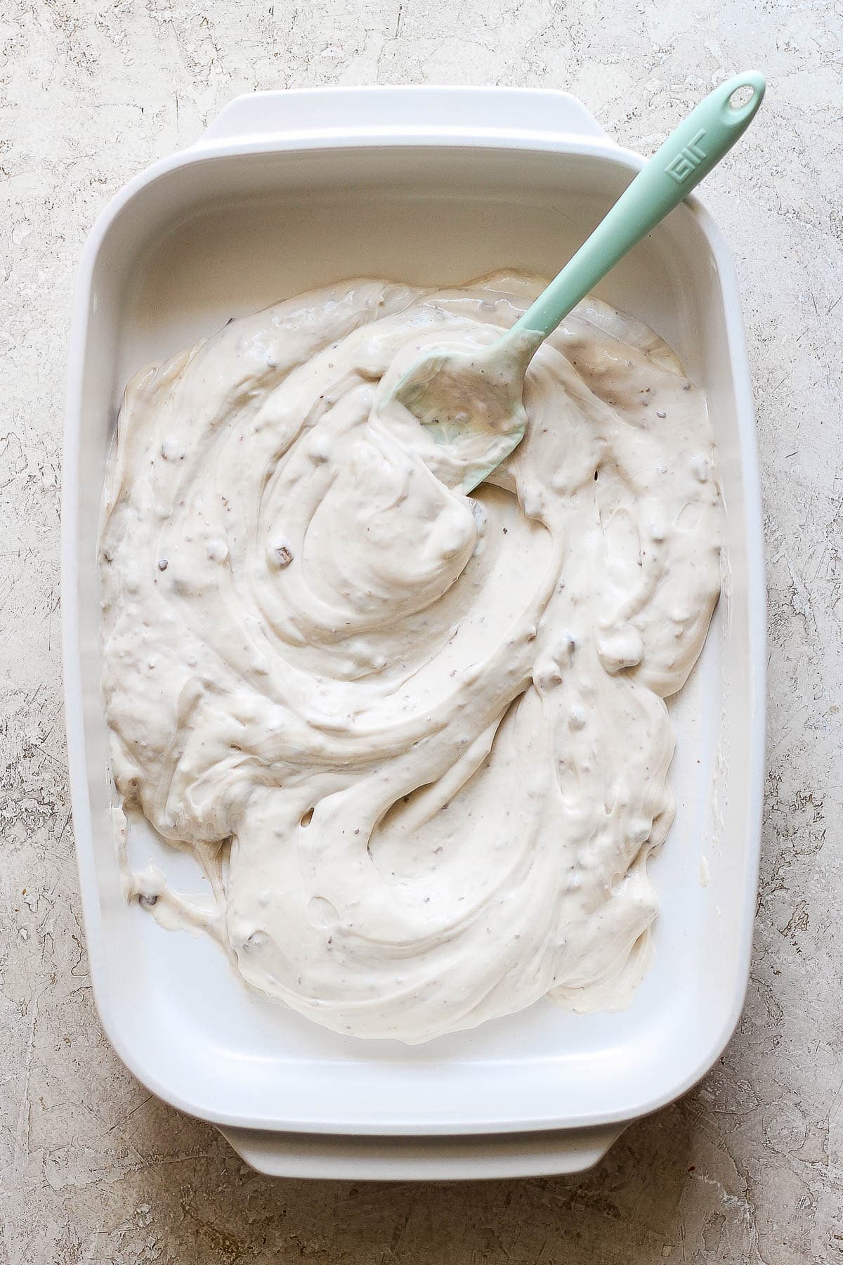 Cream of mushroom soup, mayo, and black pepper mixed in the casserole dish.