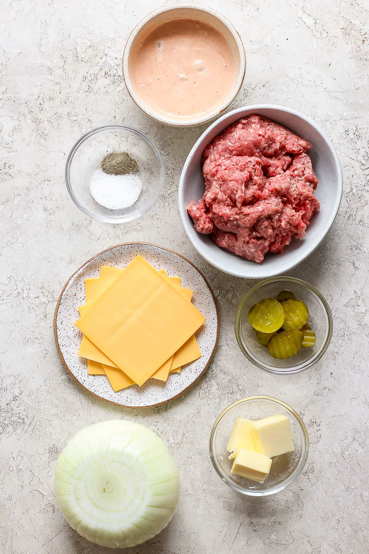 Ingredients for a flying dutchman burger in separate bowls.