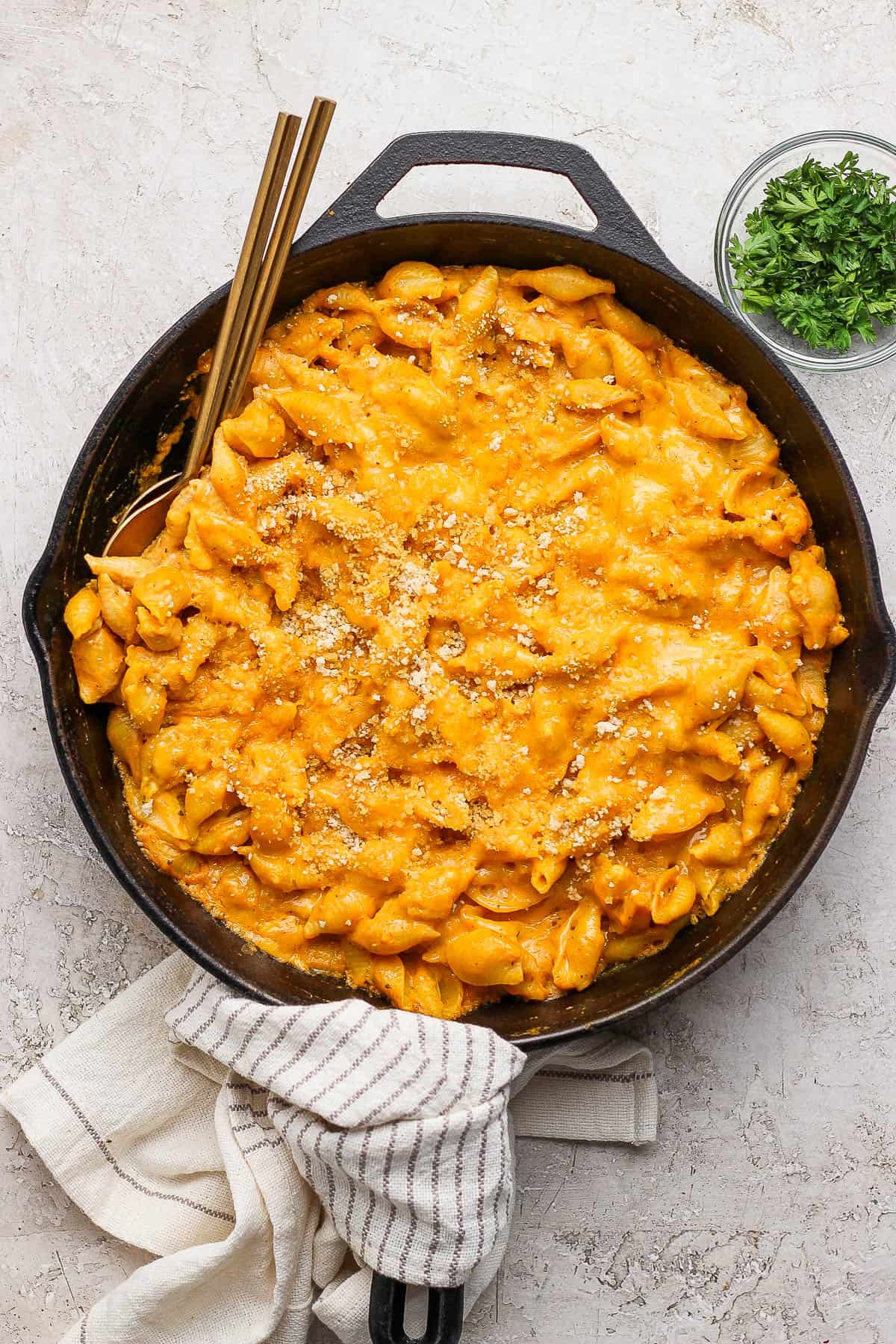 Baked pumpkin mac and cheese in a cast iron skillet.