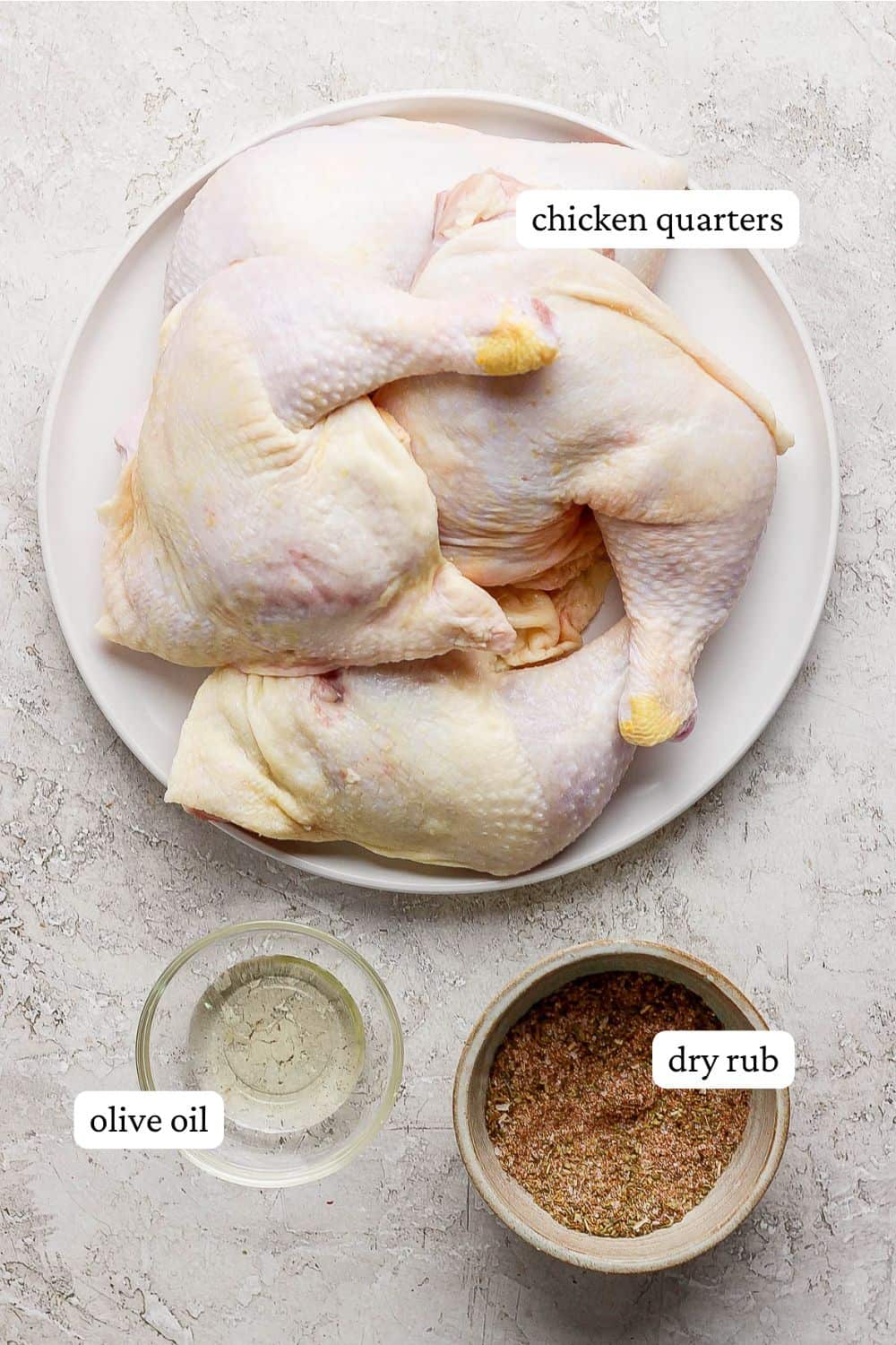 A plate of raw chicken leg quarters, a bowl of dry rub and a bowl of olive oil. 