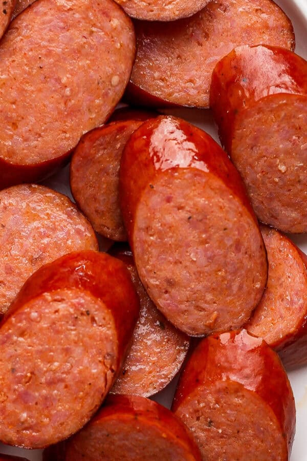 A plate full of sliced smoked sausage.
