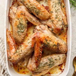 Top down shot of a pan of herbed butter baked turkey wings.