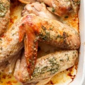 Top down shot of a pan of herbed butter baked turkey wings.