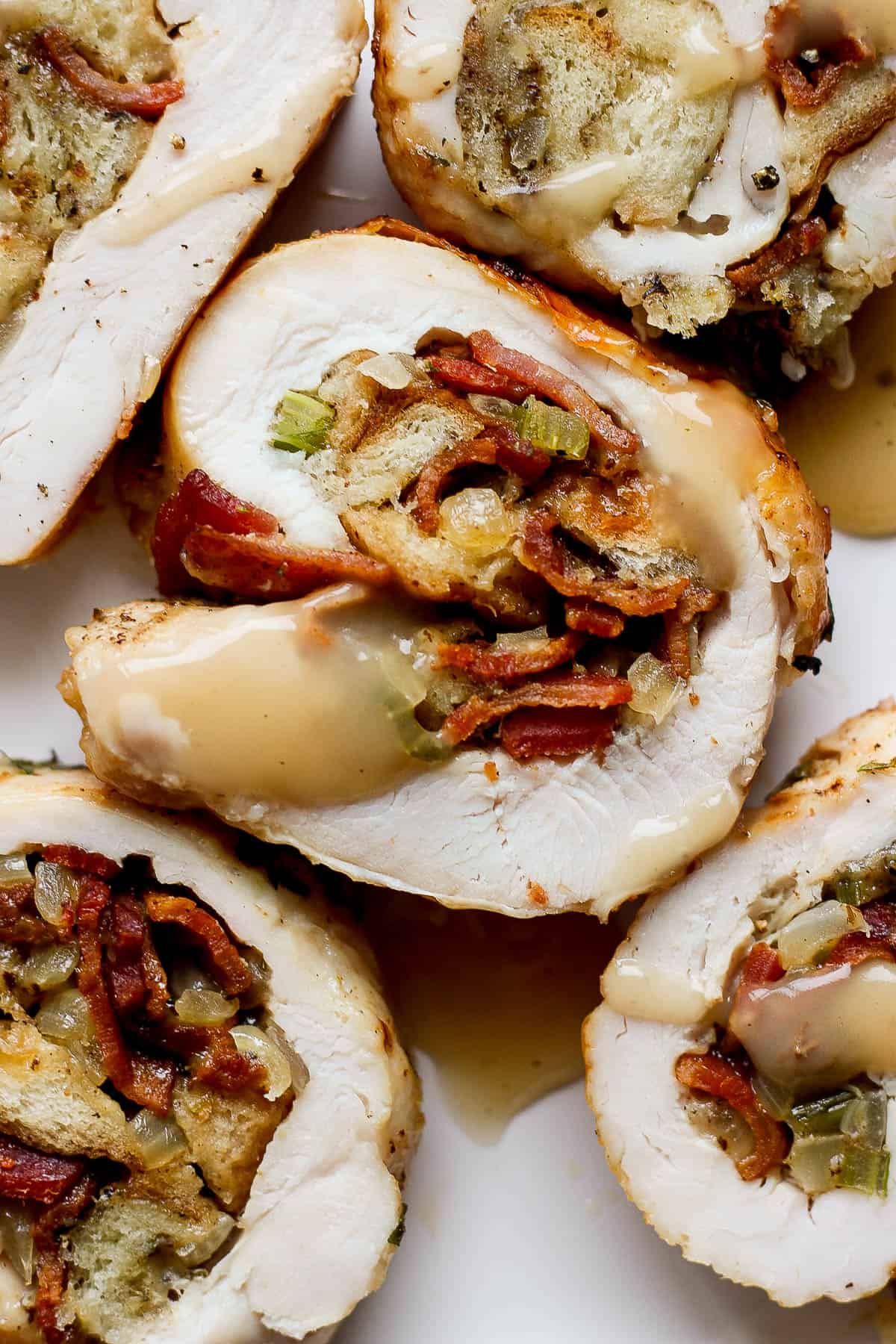 Slices of stuffed turkey breast drizzled with gravy. 