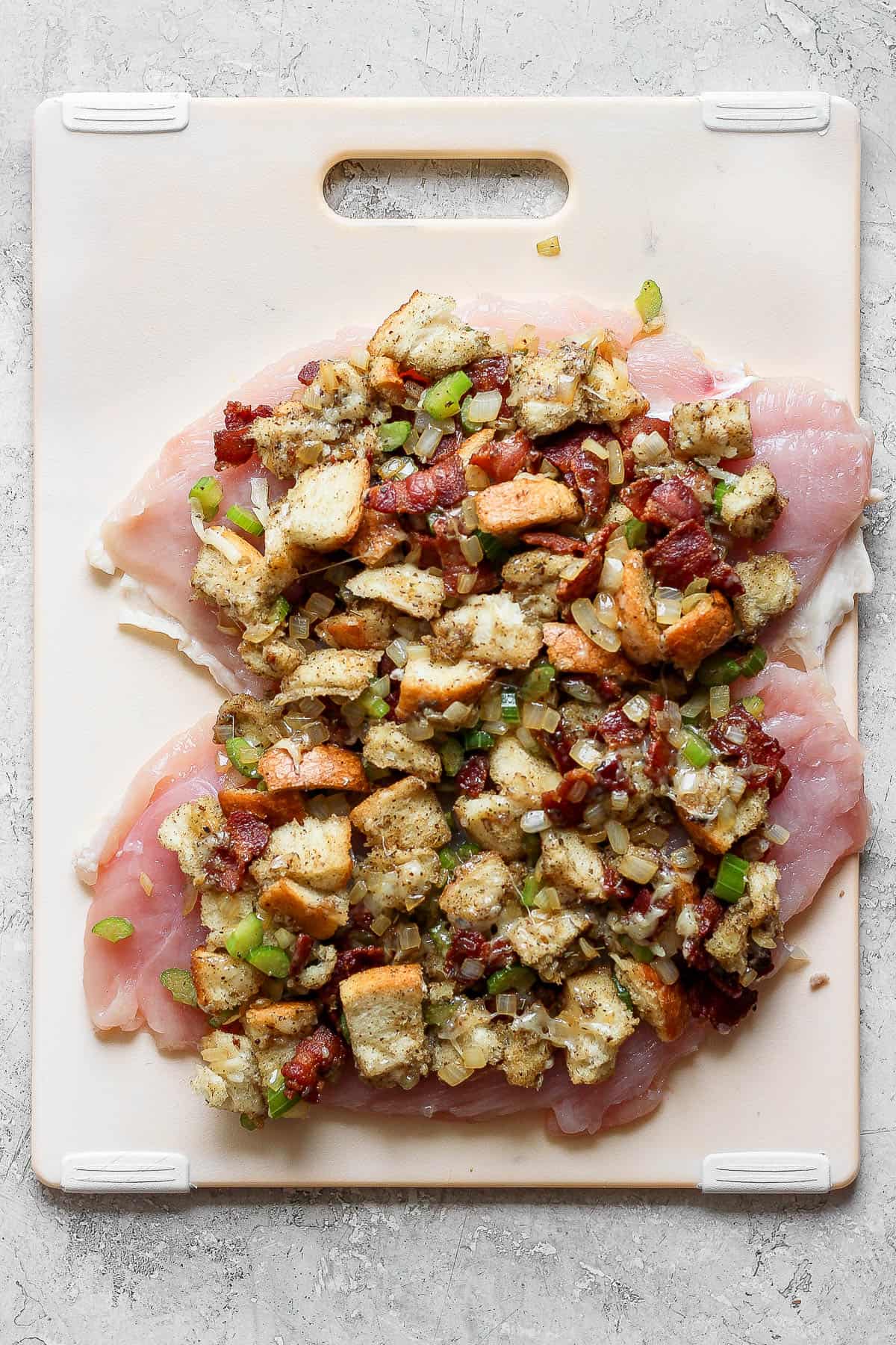 Stuffing placed on top of the butterflied turkey breast.