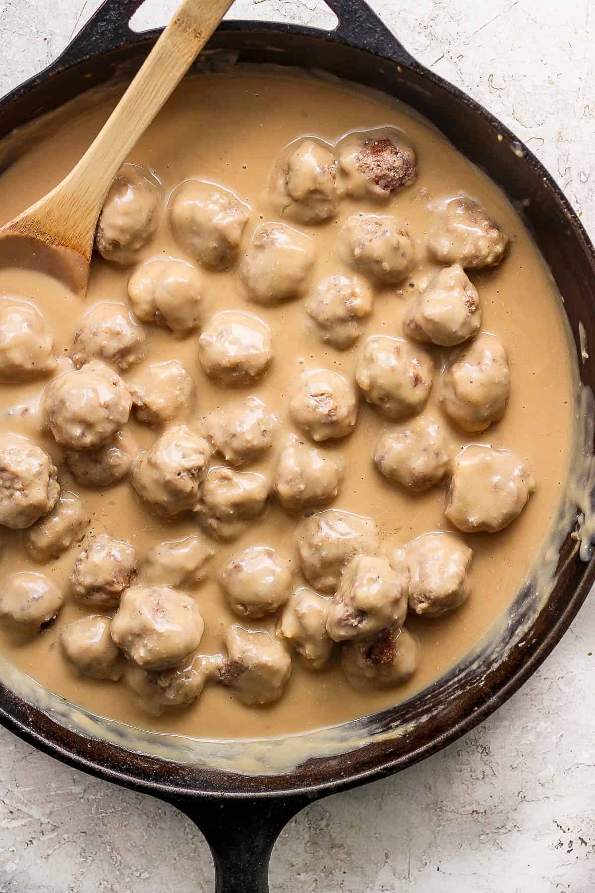 Meatballs added back to the gravy in the skillet.