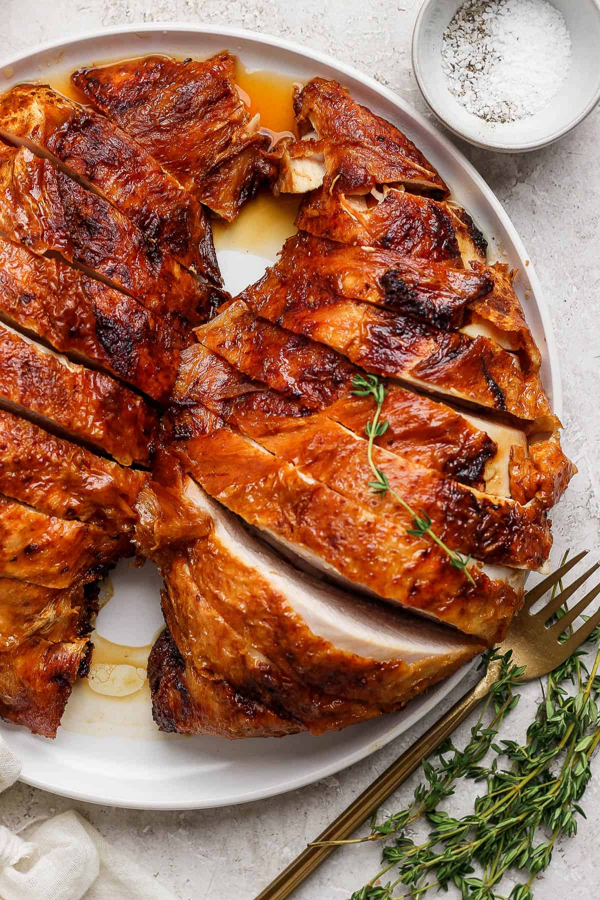 Sliced turkey breast on a white plate.