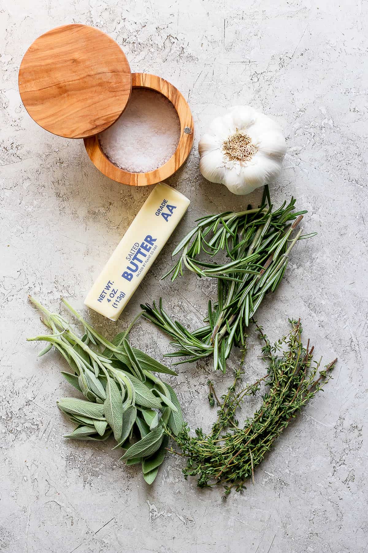 Ingredients for herbed butter on the counter top.