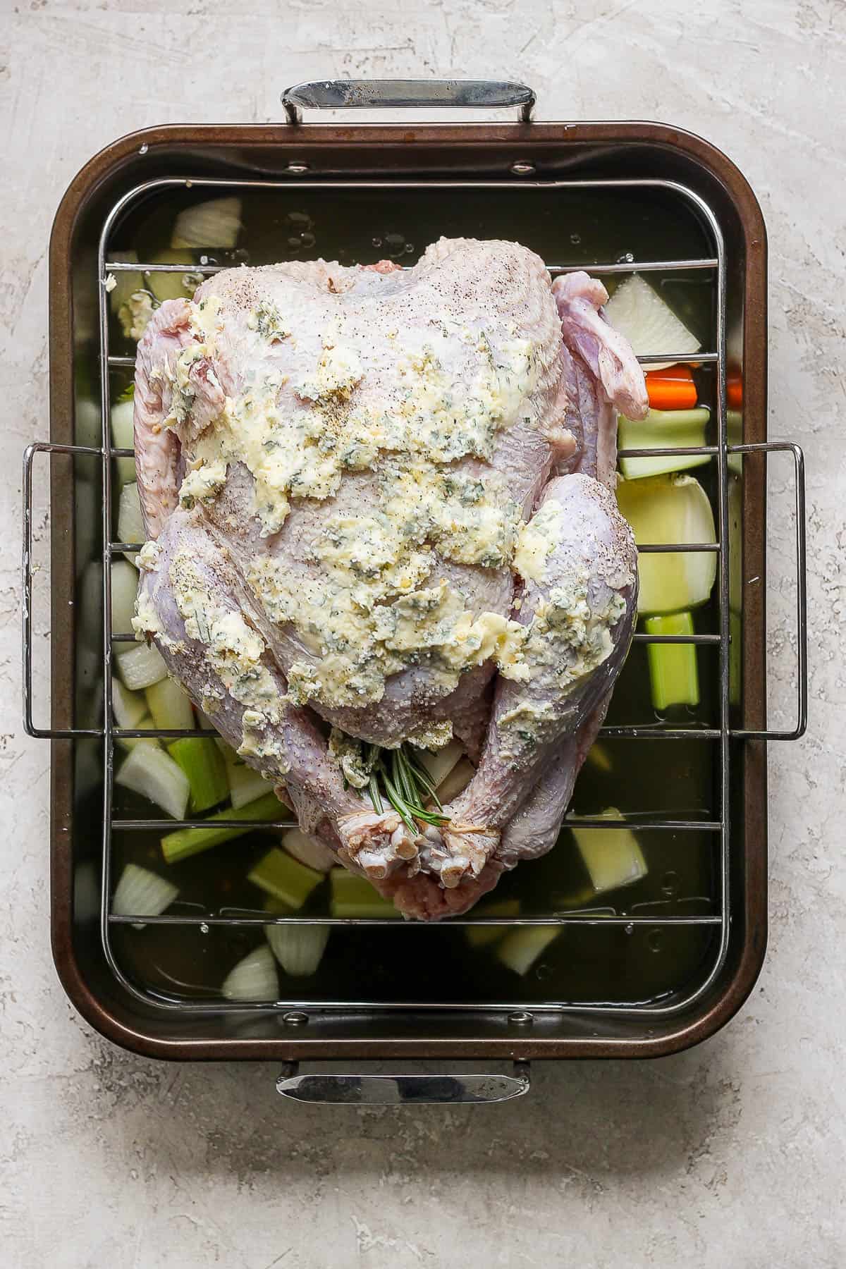 Herbed butter spread on the outside of a turkey.