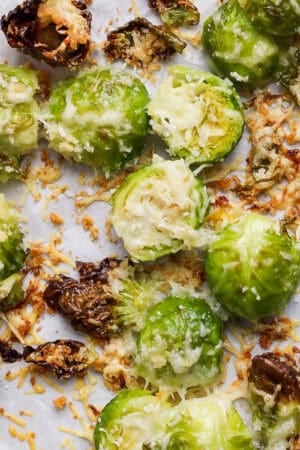 Top down shot of a cooked parmesan brussel sprouts on a baking sheet.