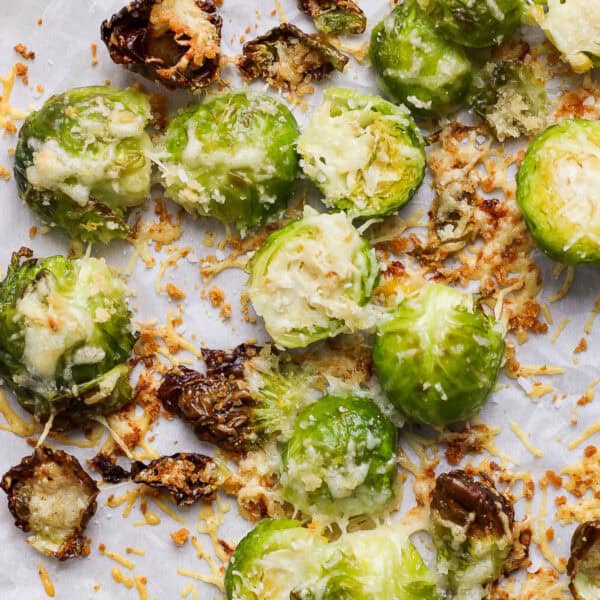 Top down shot of a cooked parmesan brussel sprouts on a baking sheet.