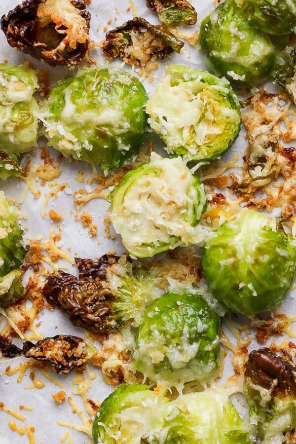 Top down shot of a cooked parmesan brussel sprouts on a baking sheet.