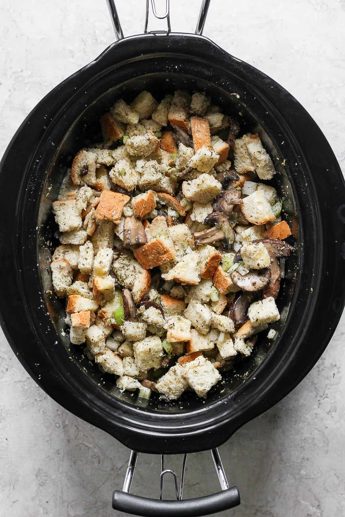 A fully mixed stuffing in the crock pot before cooking.