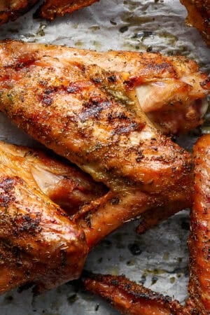 Top down shot of a smoked turkey wing a parchment-lined baking sheet.