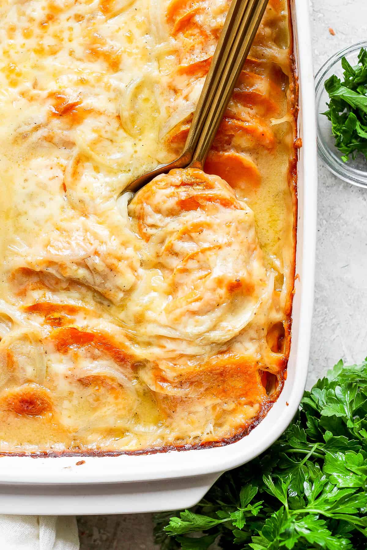 Sweet potato au gratin in a baking dish.