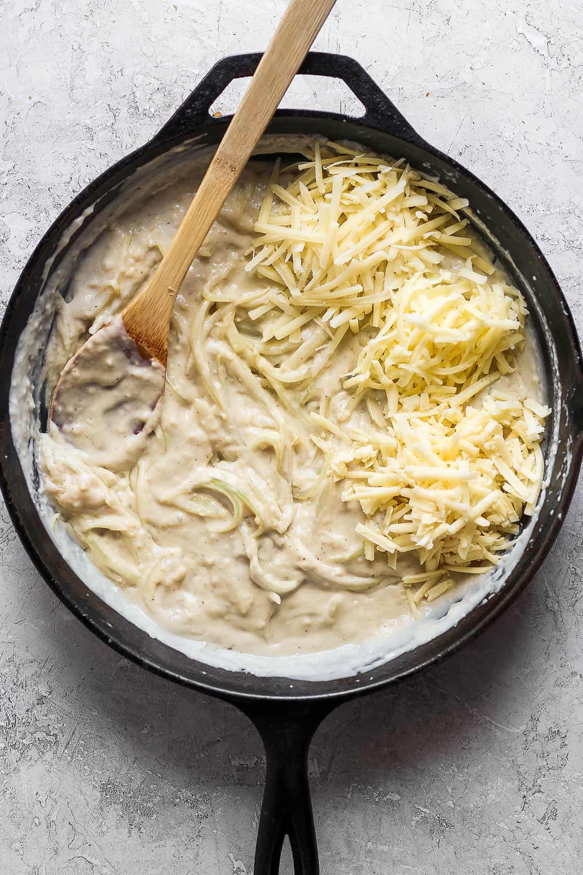 Sliced onions and grated cheese added into the cream sauce.