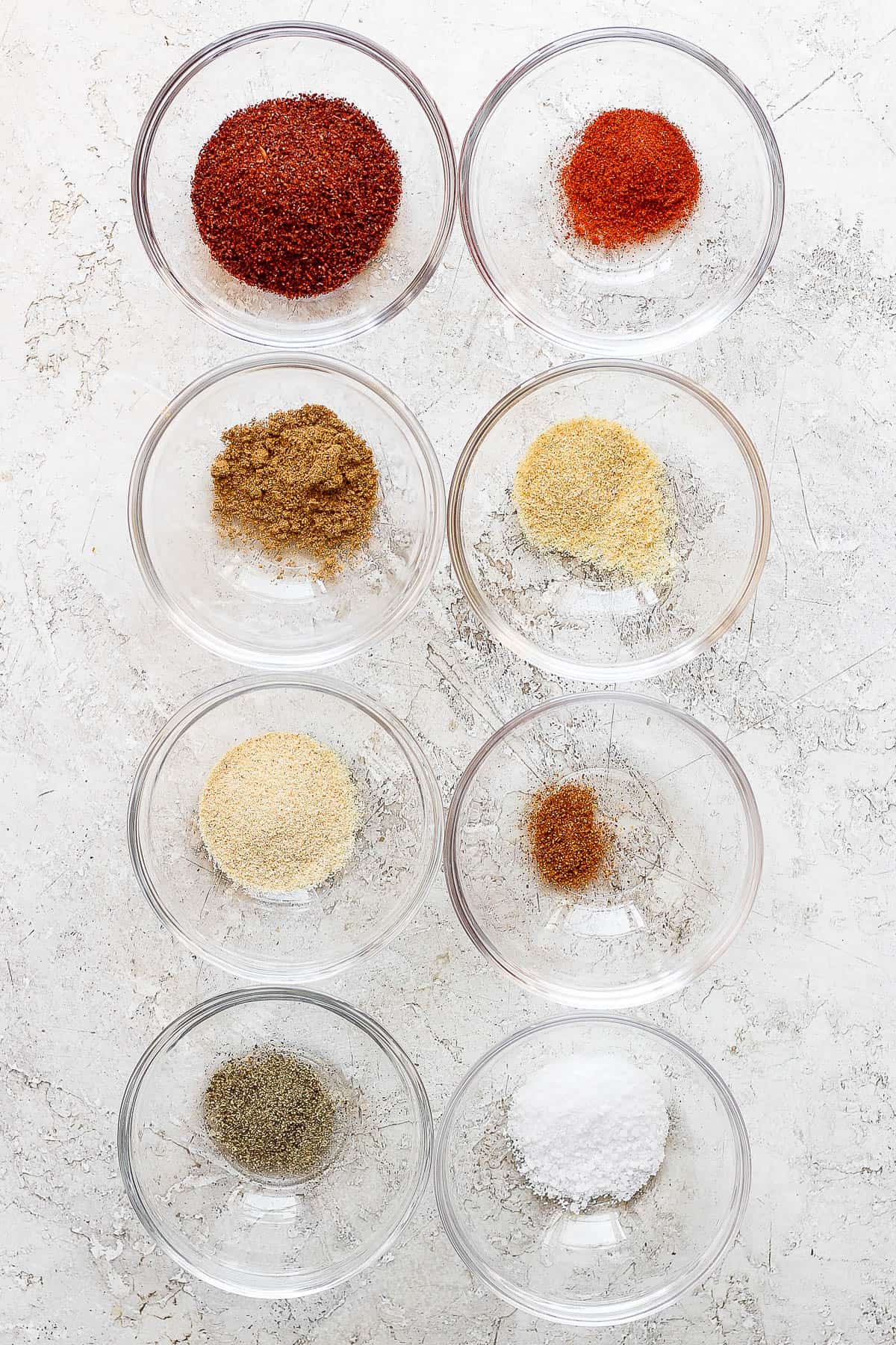 Taco seasoning ingredients in separate bowls.