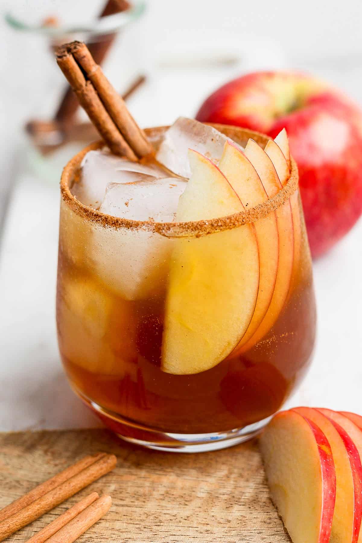 A fully garnished apple cider bourbon cocktail.