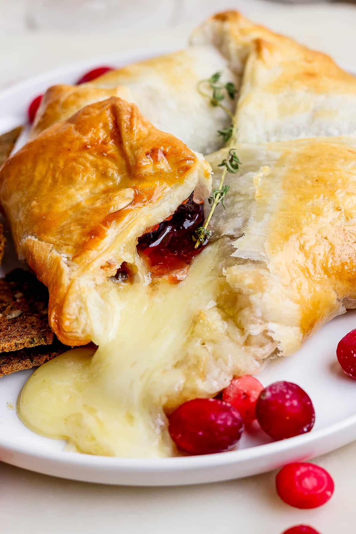 A close up shot of melted brie coming out of the puff pastry.