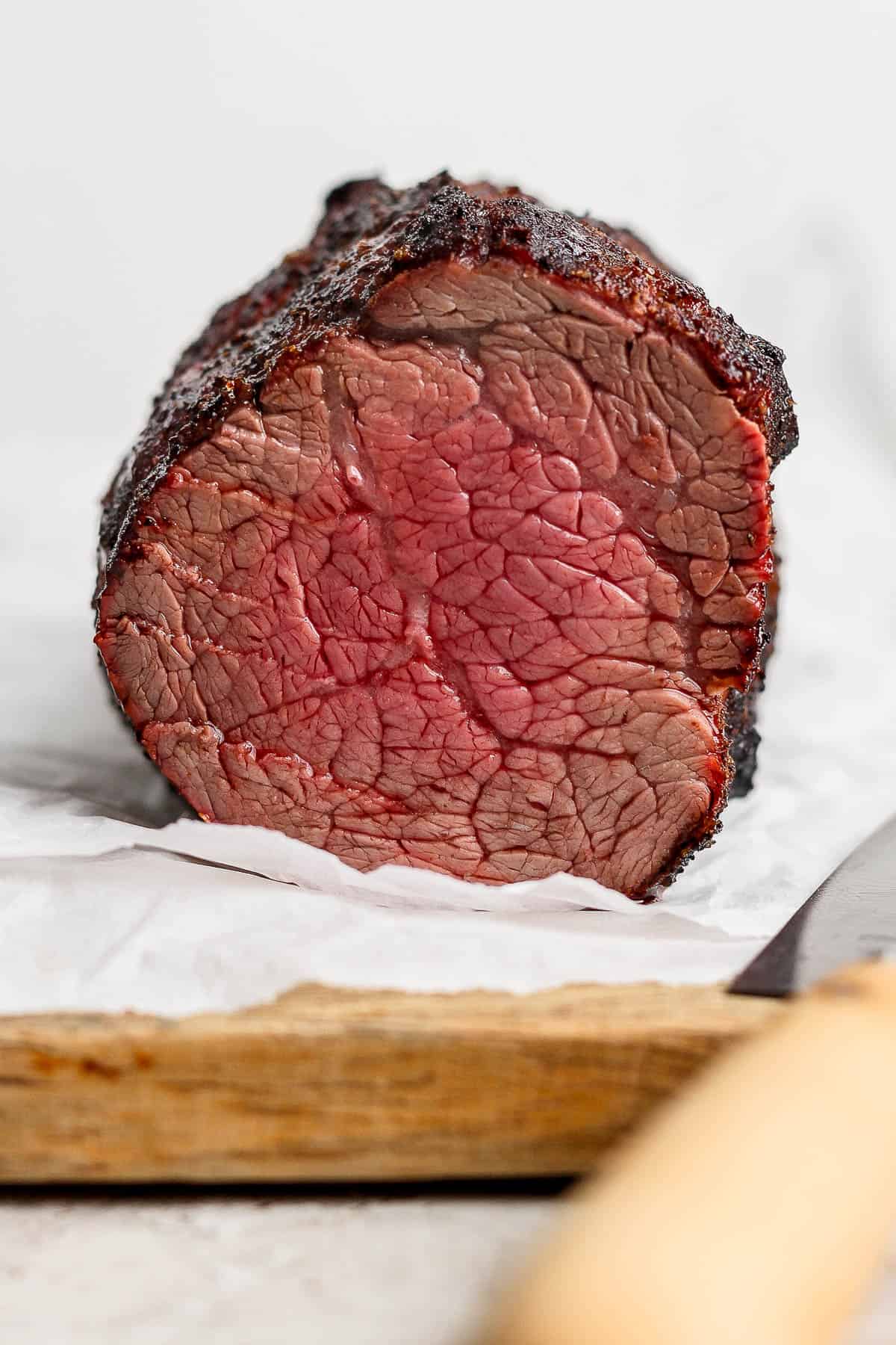 A grilled beef tenderloin after being cut to show the pink inside.