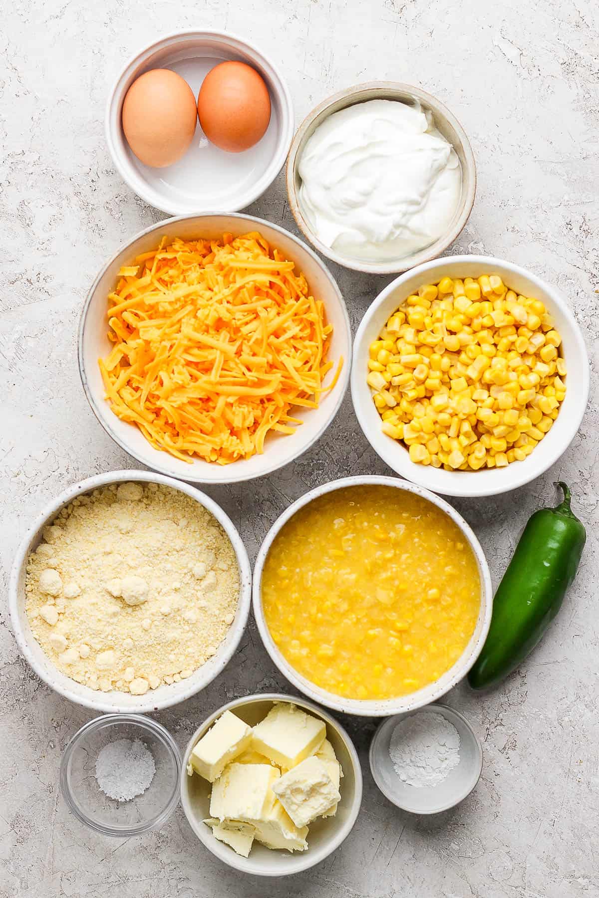 Ingredients for corn casserole in separate bowls.