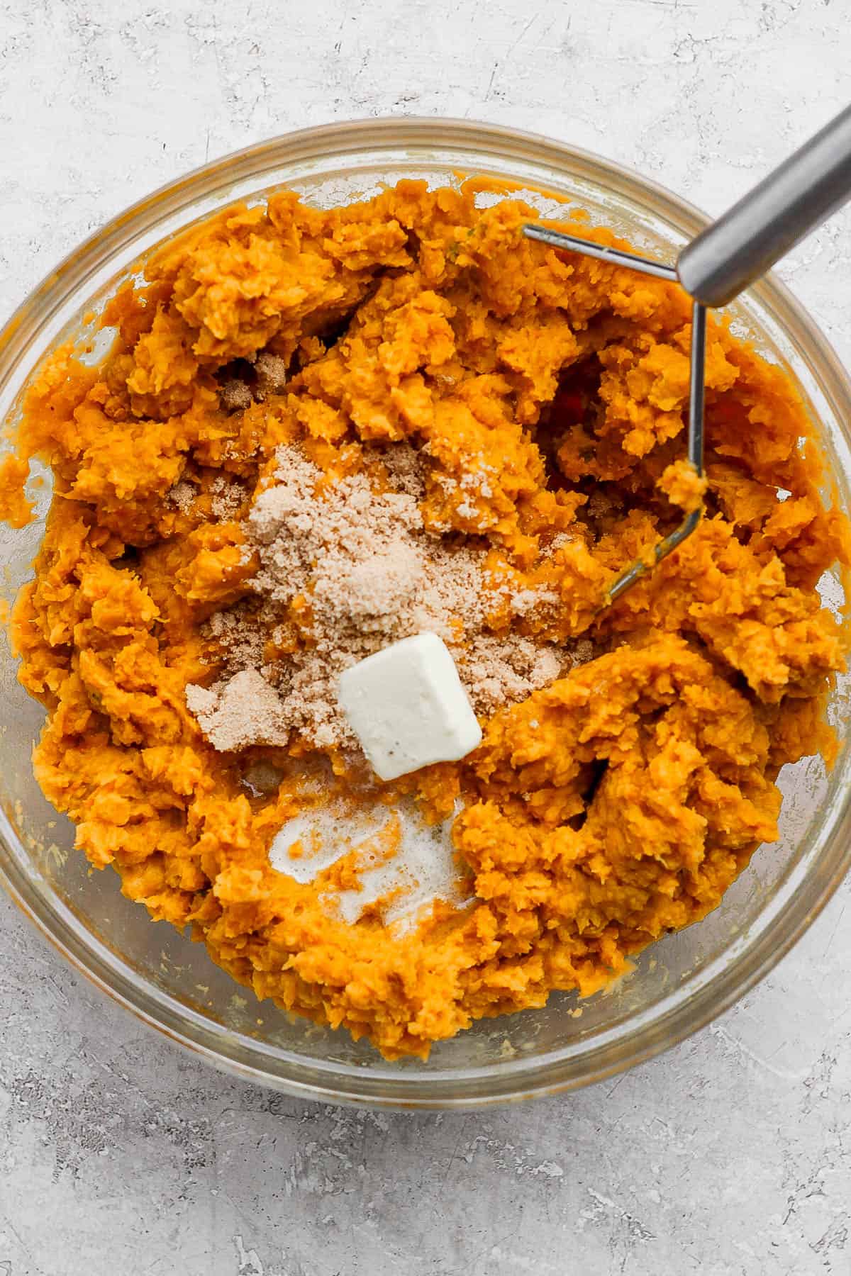 All of the ingredients mashed in a big glass bowl.