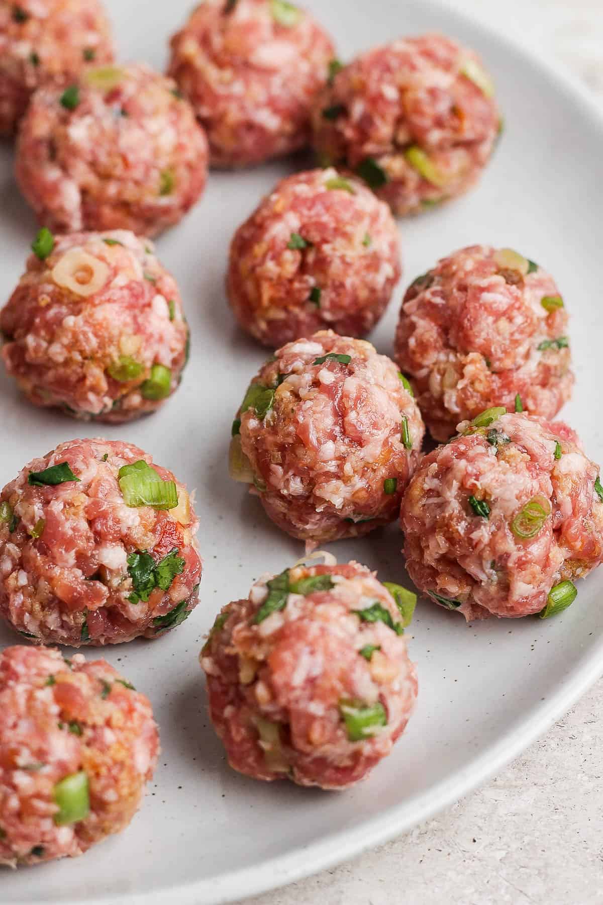 Raw meatballs on a plate.