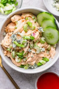 buffalo ranch chicken salad in a bowl topped with green onins.