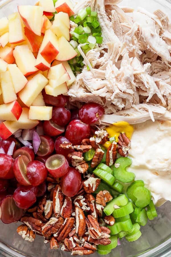 Top down shot of a bowl filled with all the ingredients for chicken salad with grapes, but unmixed.