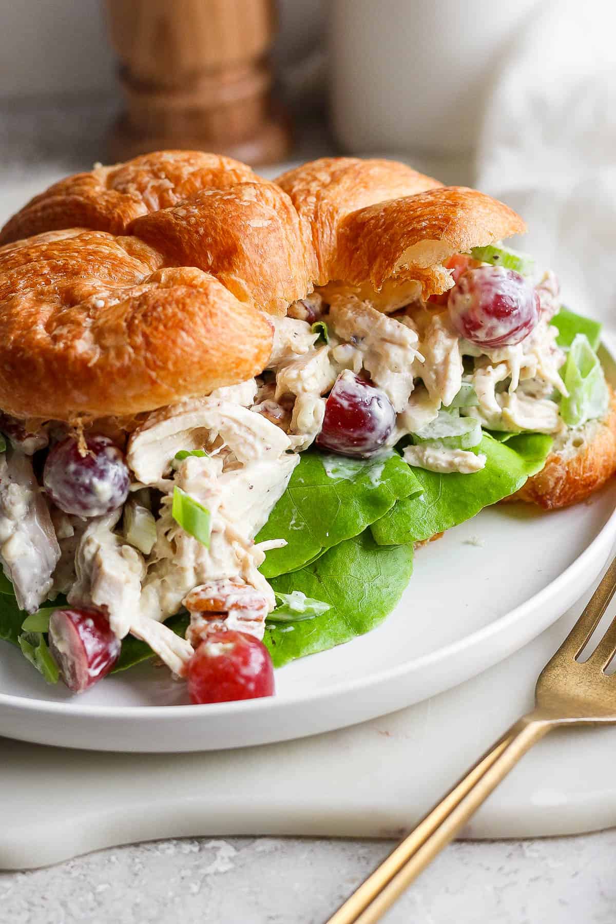 Chicken salad on a butter croissant with butter lettuce.